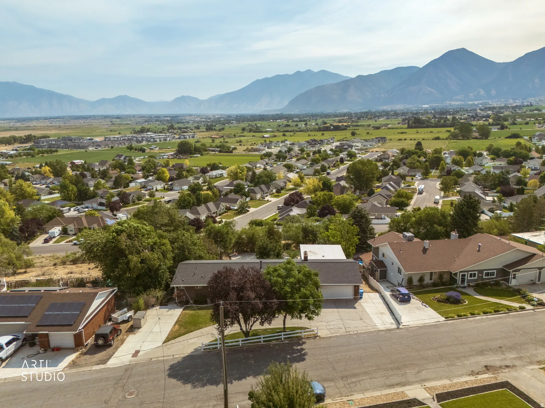 Aerial perspective showcasing a residential neighborhood with distant mountain scenery
