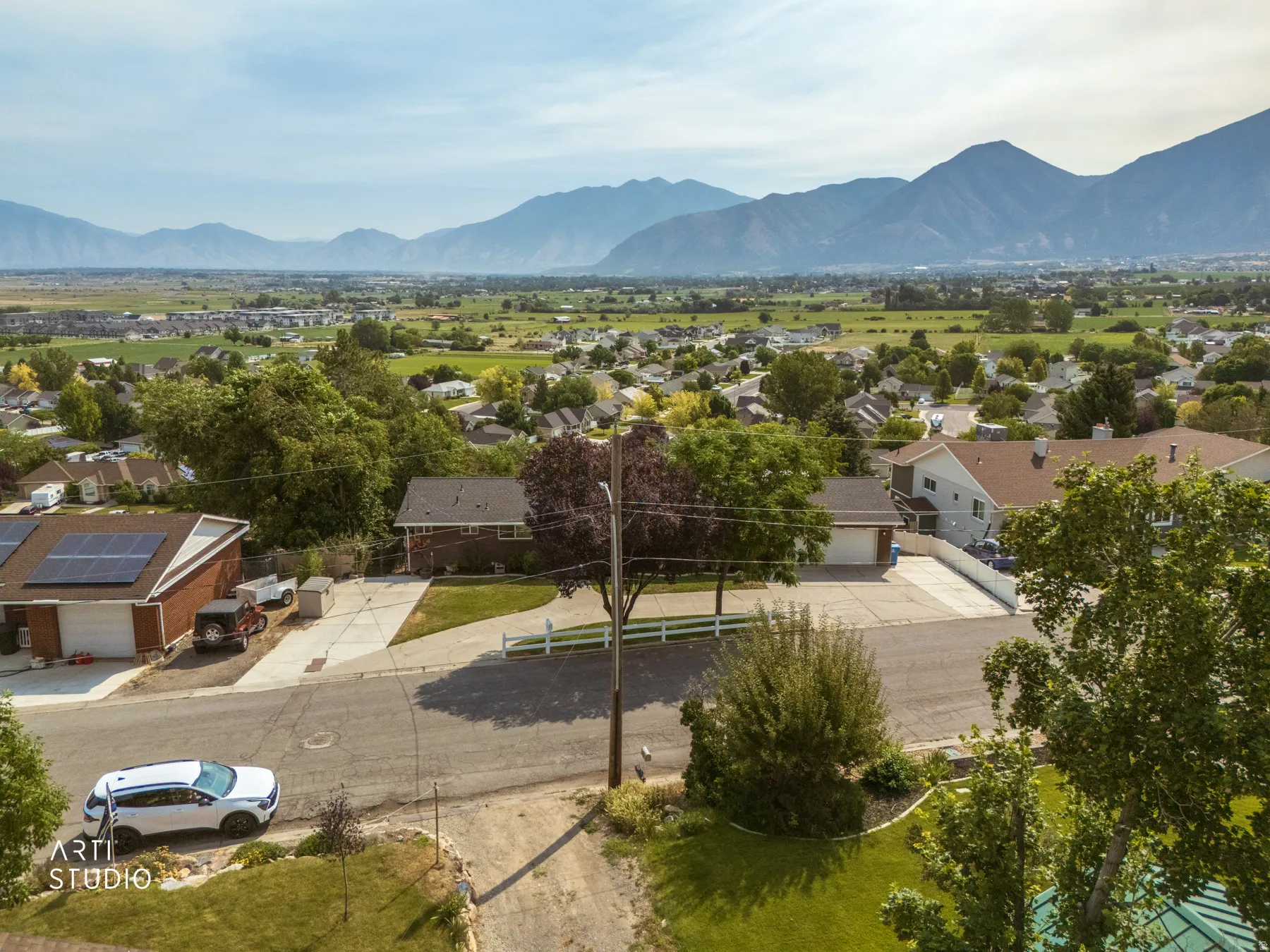 Expansive mountainous scenery frames the surrounding neighborhood