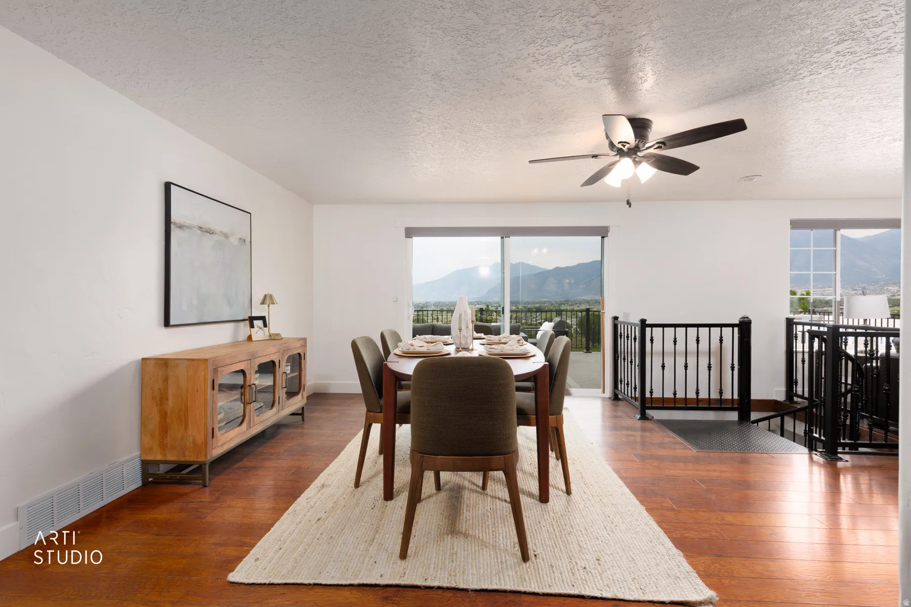 Dining area with wood-finish flooring, a contemporary ceiling fan, and sliding glass doors opening to a balcony