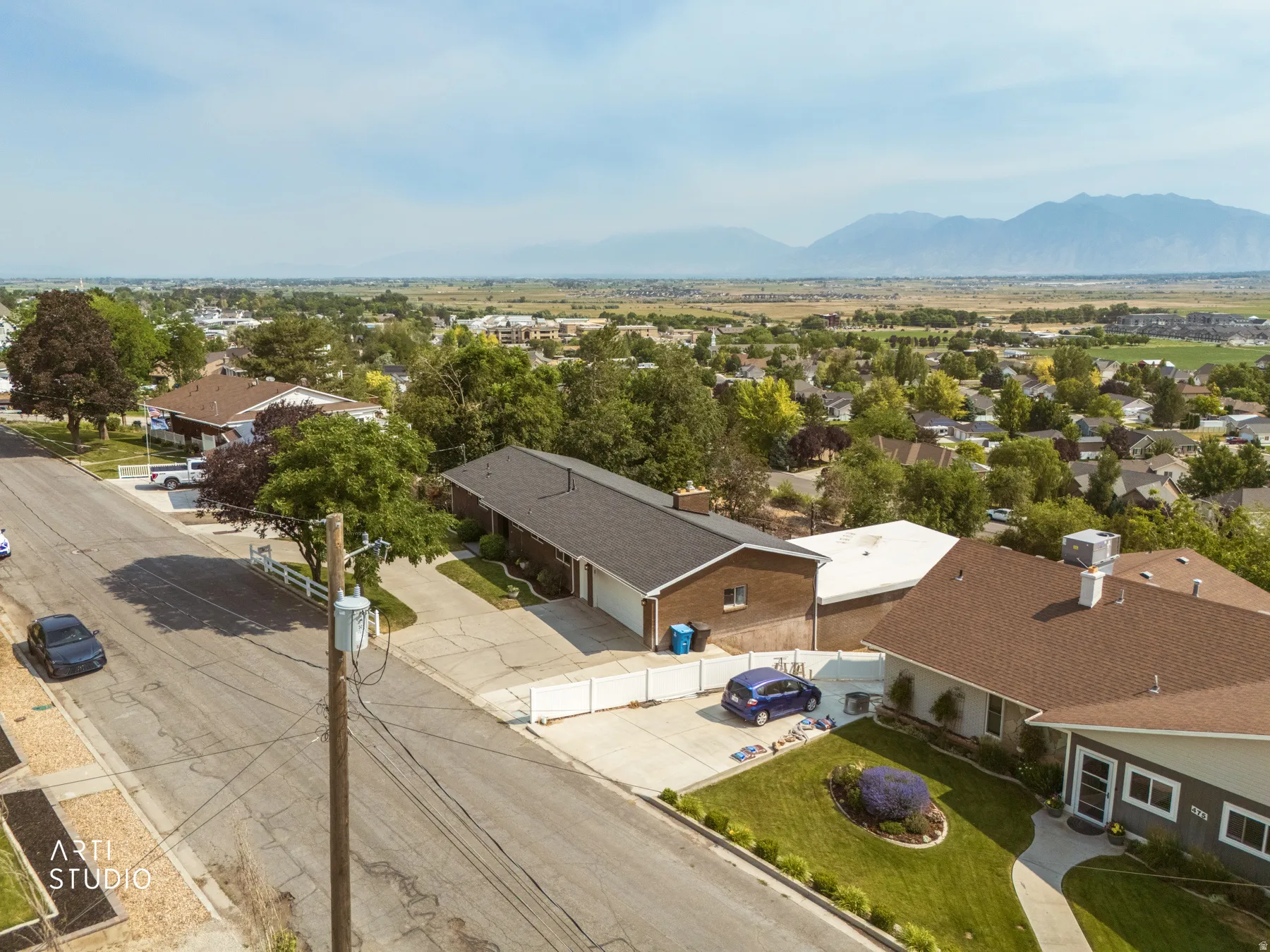 Aerial perspective showcasing a residential street with mountain scenery