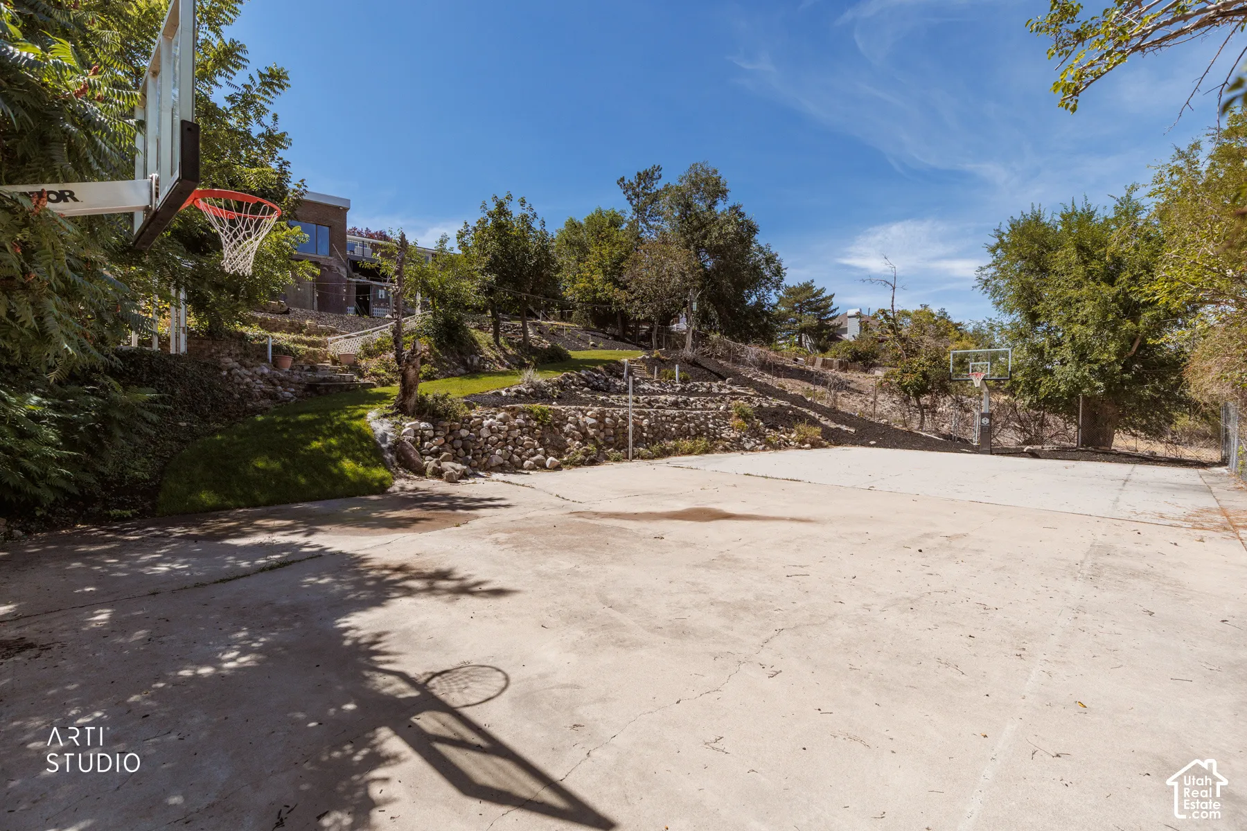 Concrete sports court with two basketball hoops