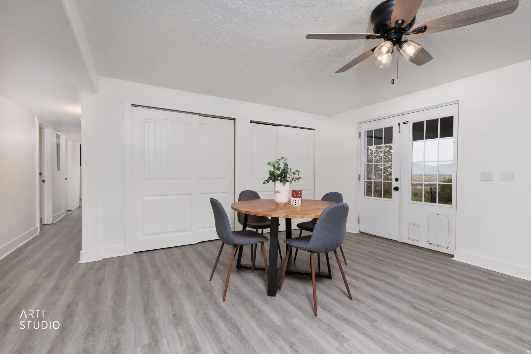 Spacious room featuring light wood-finish flooring and white walls