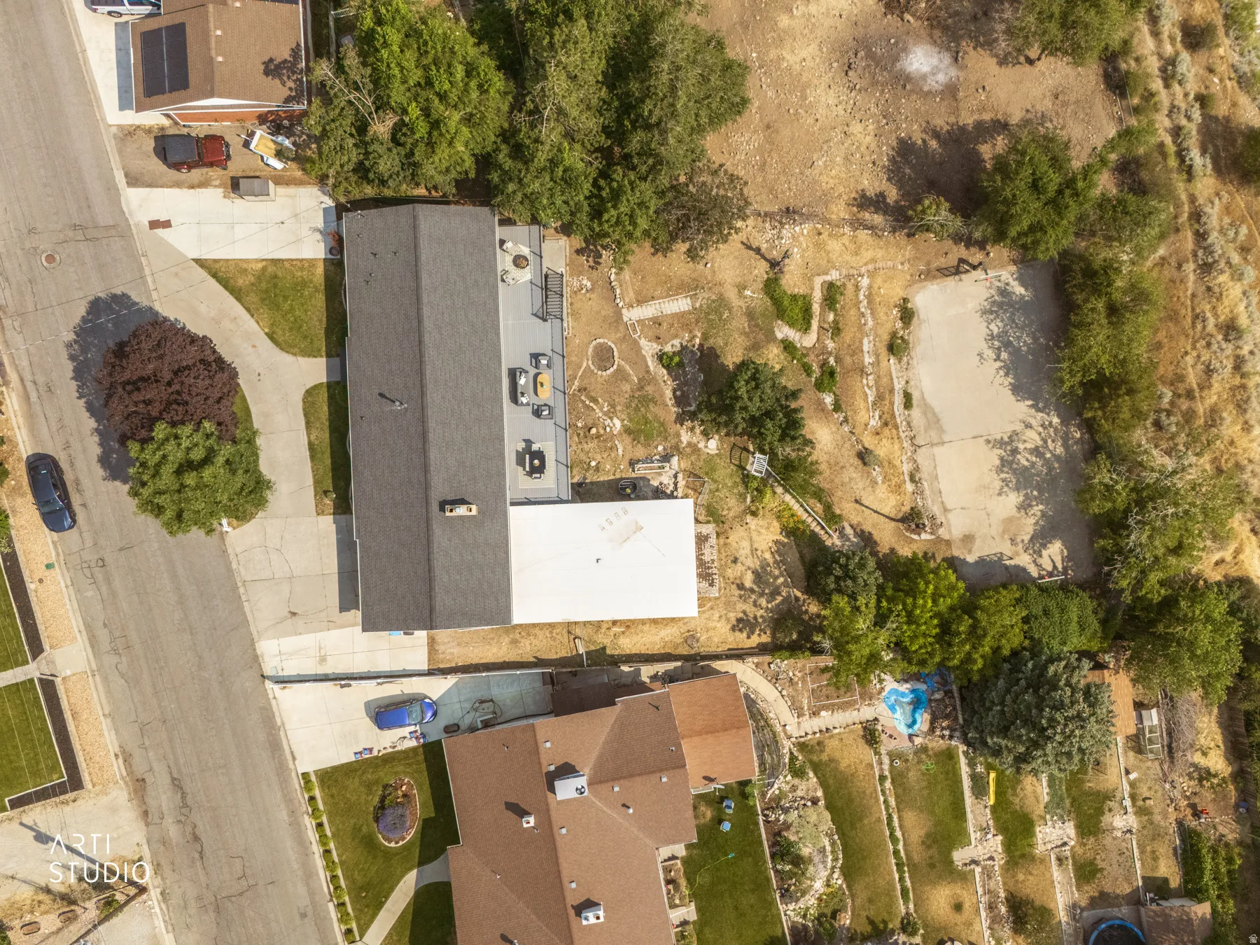 Spacious property featuring a large backyard, mature trees, and a substantial driveway