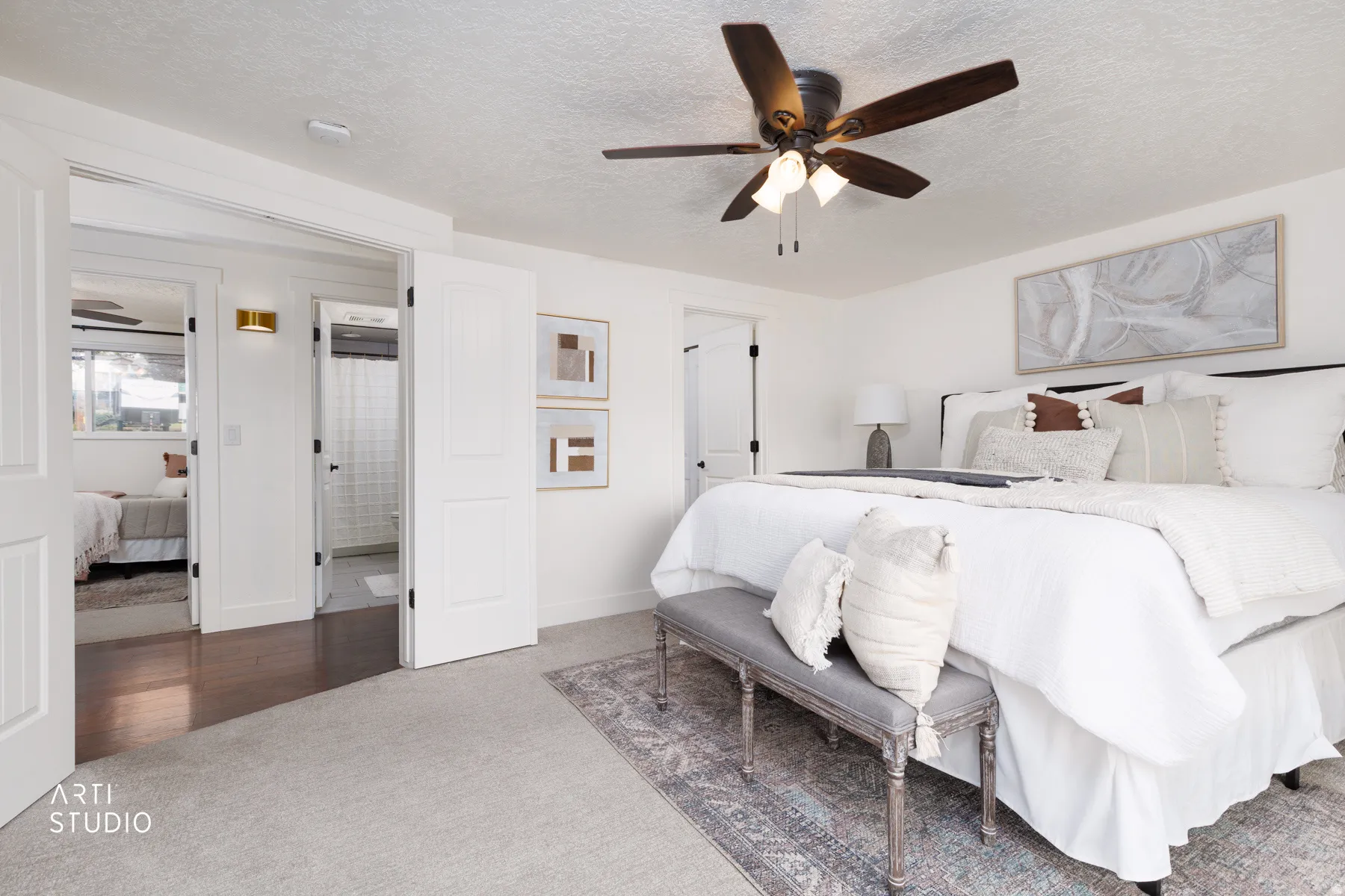 Carpeted room featuring a ceiling fan with integrated lighting, white walls, and white paneled doors