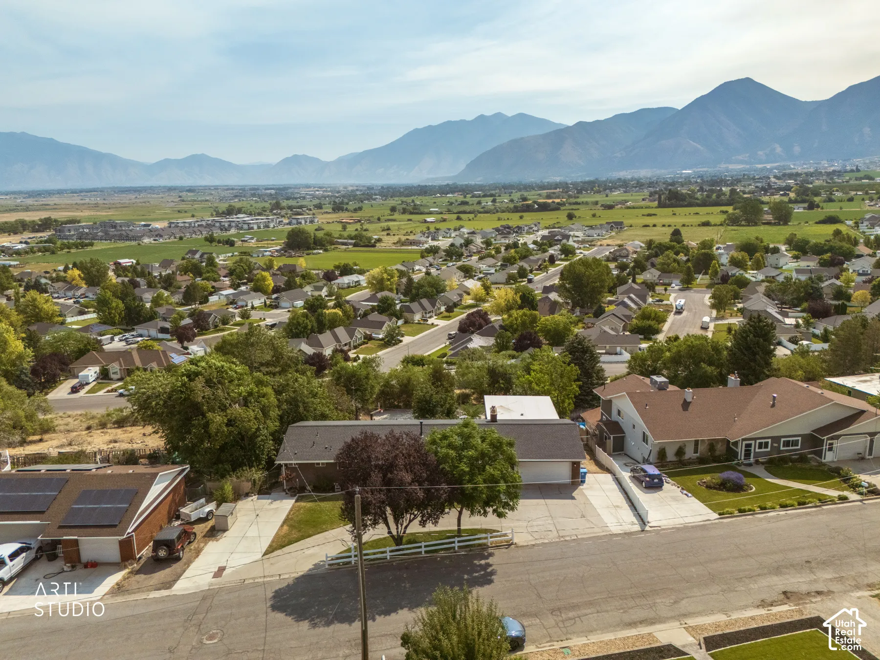 Aerial perspective showcasing a residential neighborhood with distant mountain scenery