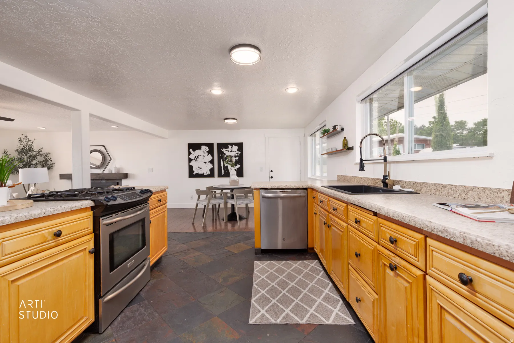 Kitchen featuring wood cabinetry and slate-style floor tile