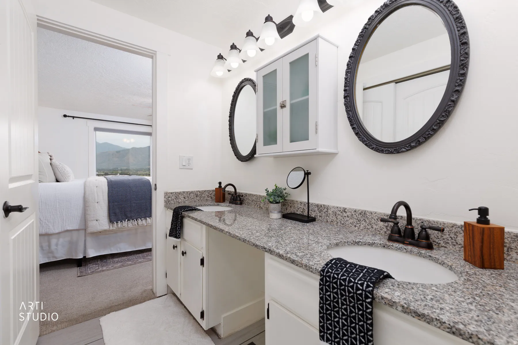Double vanity featuring quartz-finish countertops, undermount sinks, and oil-rubbed bronze fixtures