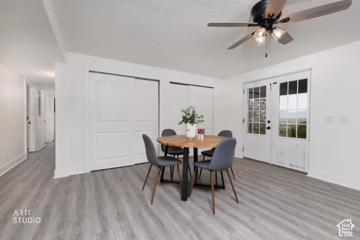 Spacious room featuring light wood-finish flooring and white walls