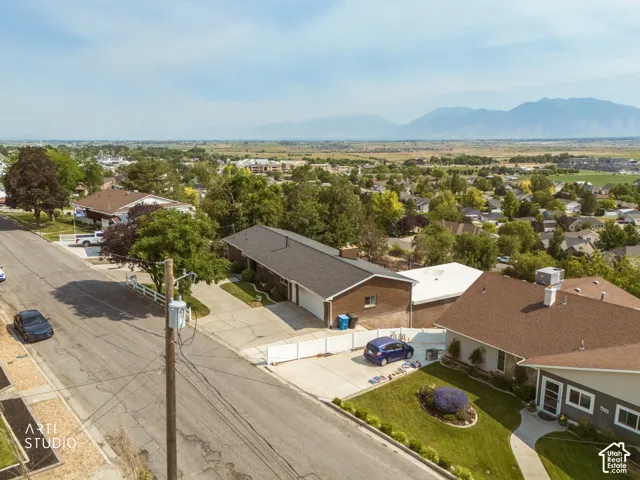 Aerial perspective showcasing a residential street with mountain scenery