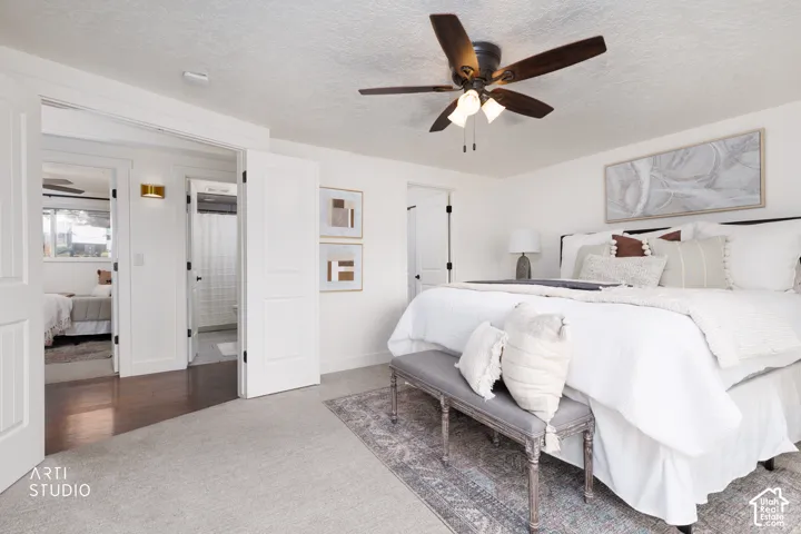 Carpeted room featuring a ceiling fan with integrated lighting, white walls, and white paneled doors