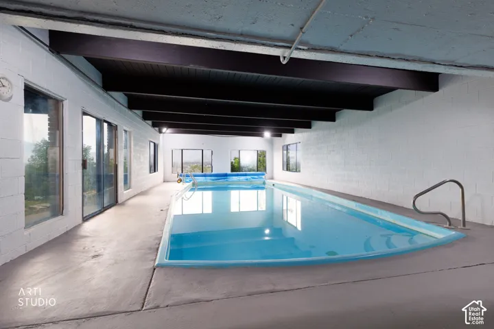 Indoor swimming pool featuring a curved end and integrated steps