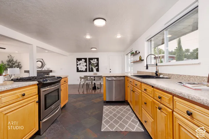 Kitchen featuring wood cabinetry and slate-style floor tile