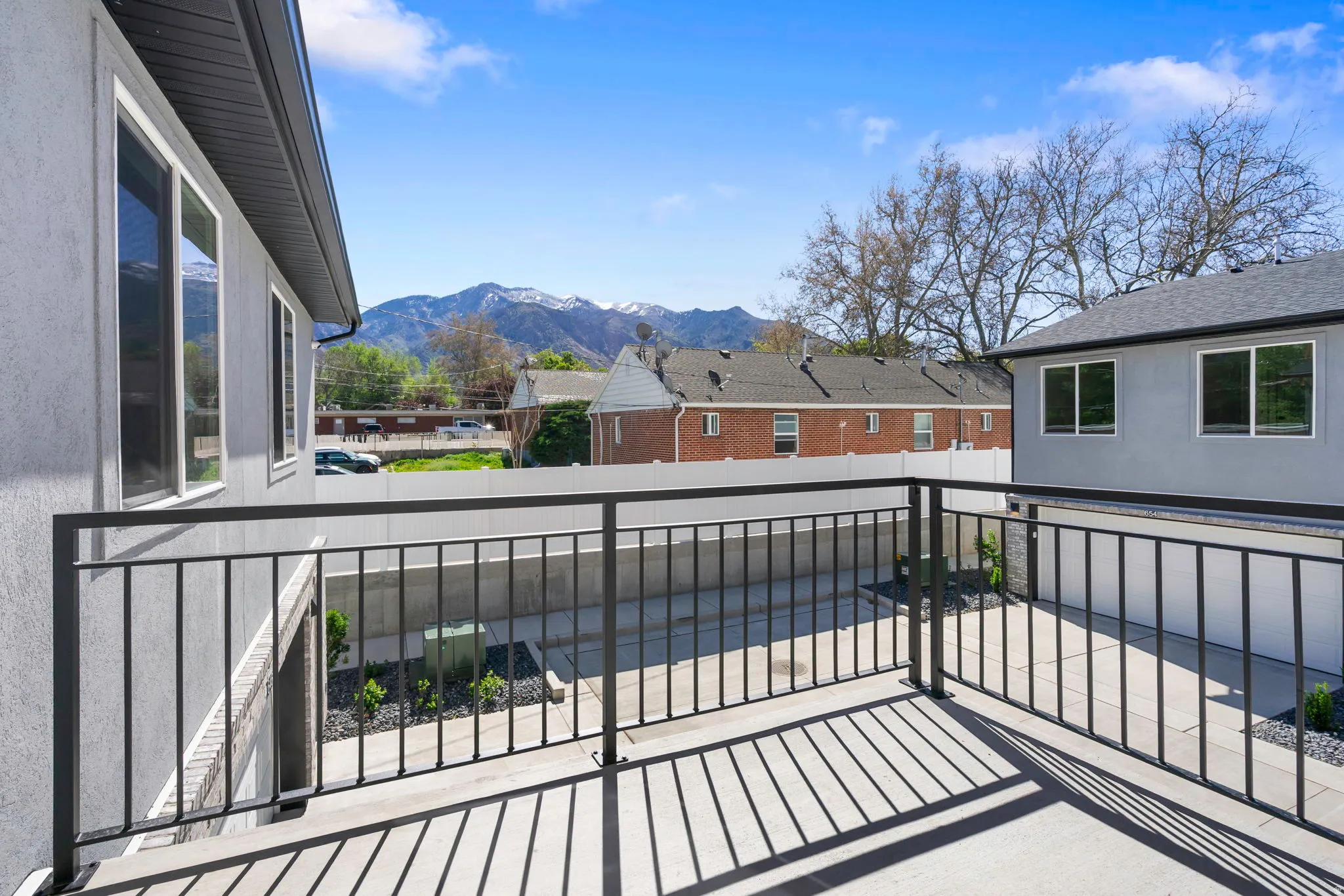 Concrete balcony featuring dark metal railings, providing an elevated outdoor space