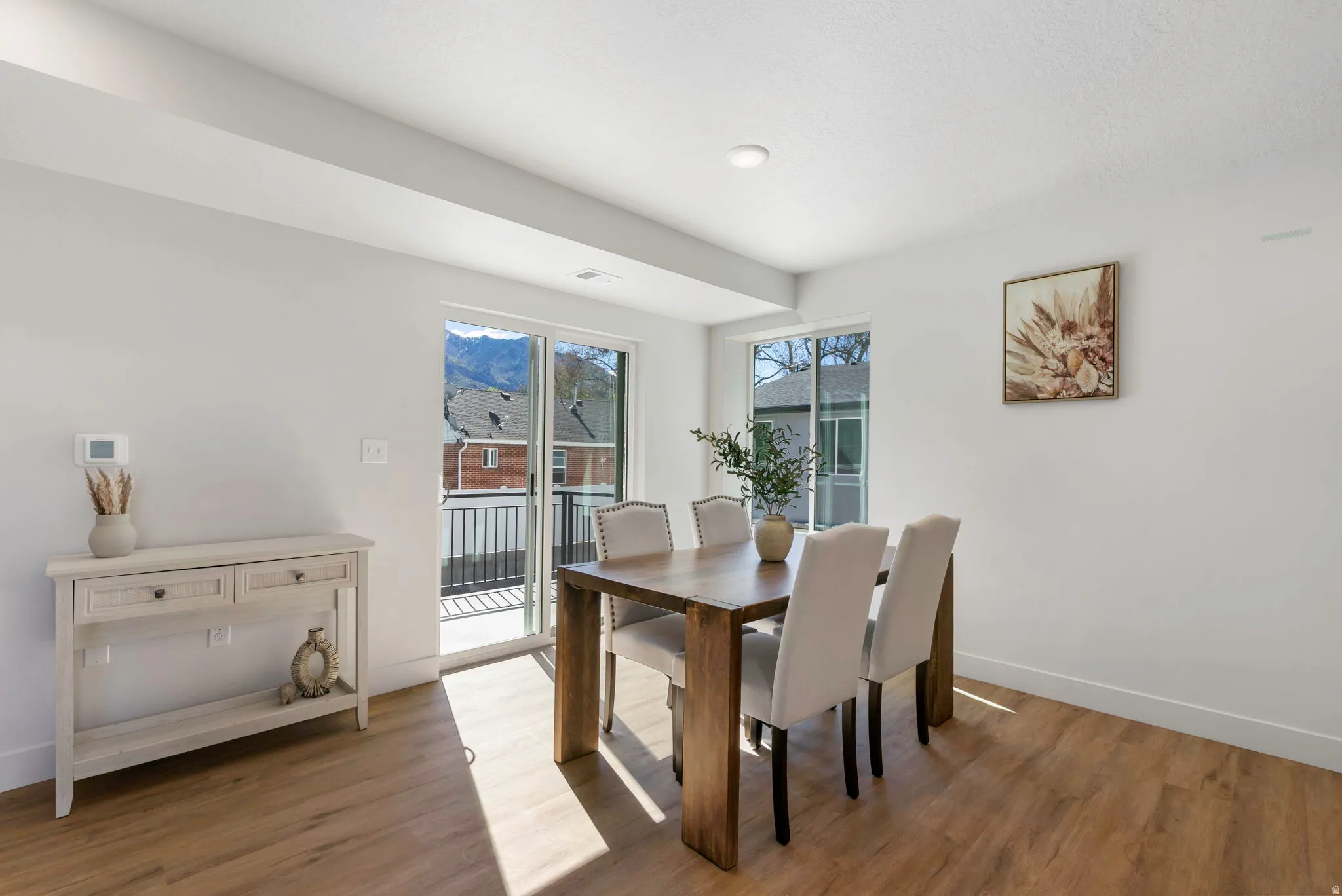 Bright interior space with wood-finish flooring and white walls