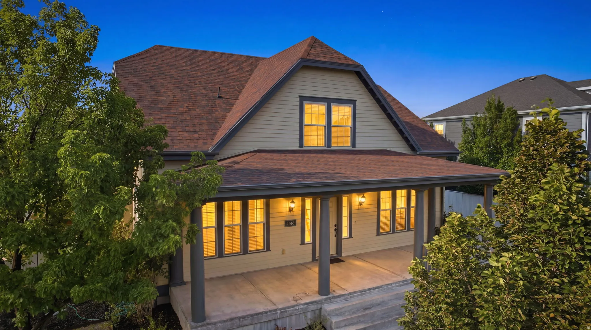 Gable-front home featuring a full-width covered porch with architectural columns