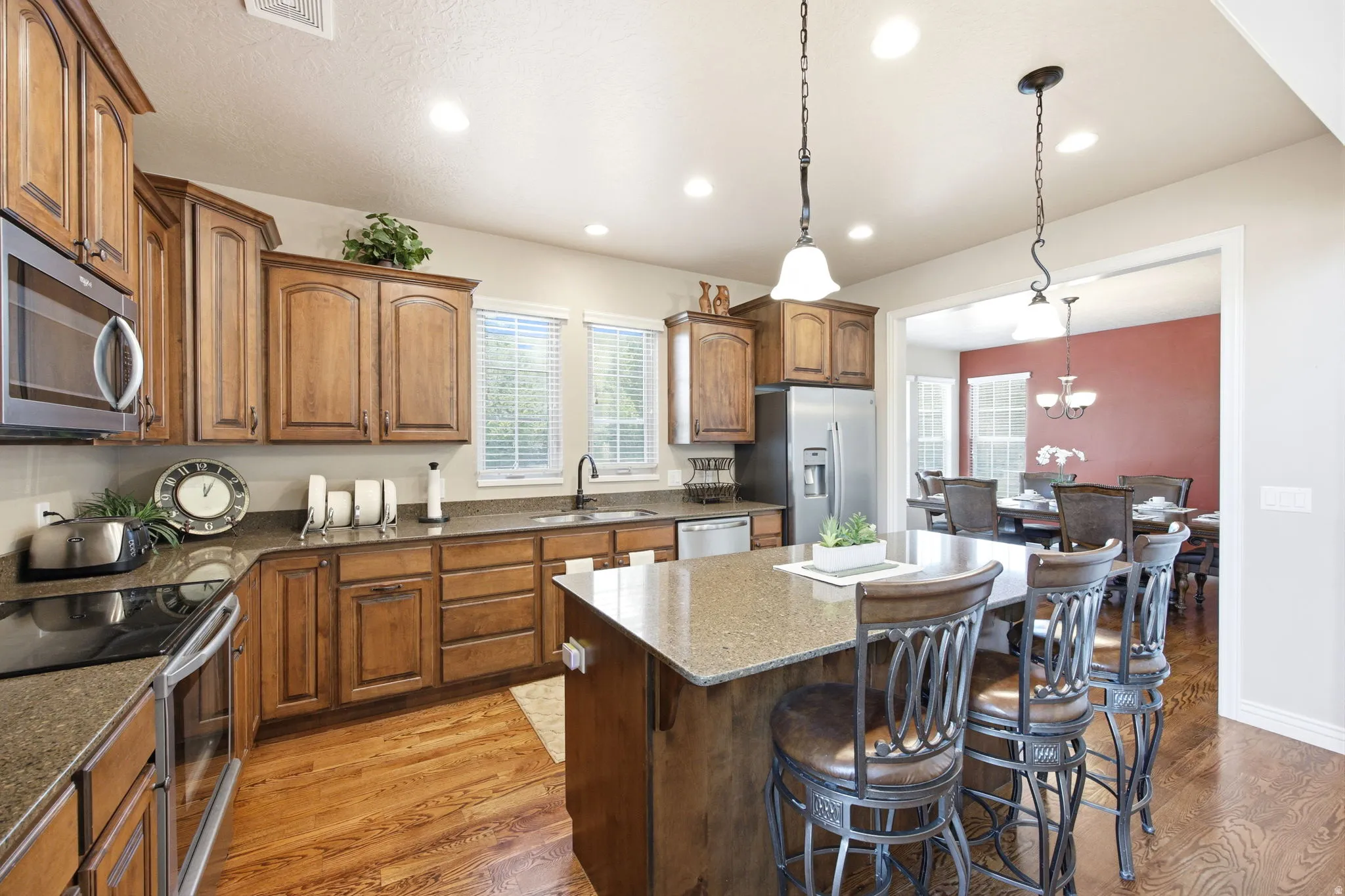 Kitchen featuring wood-finish cabinetry, stone countertops, and stainless steel appliances