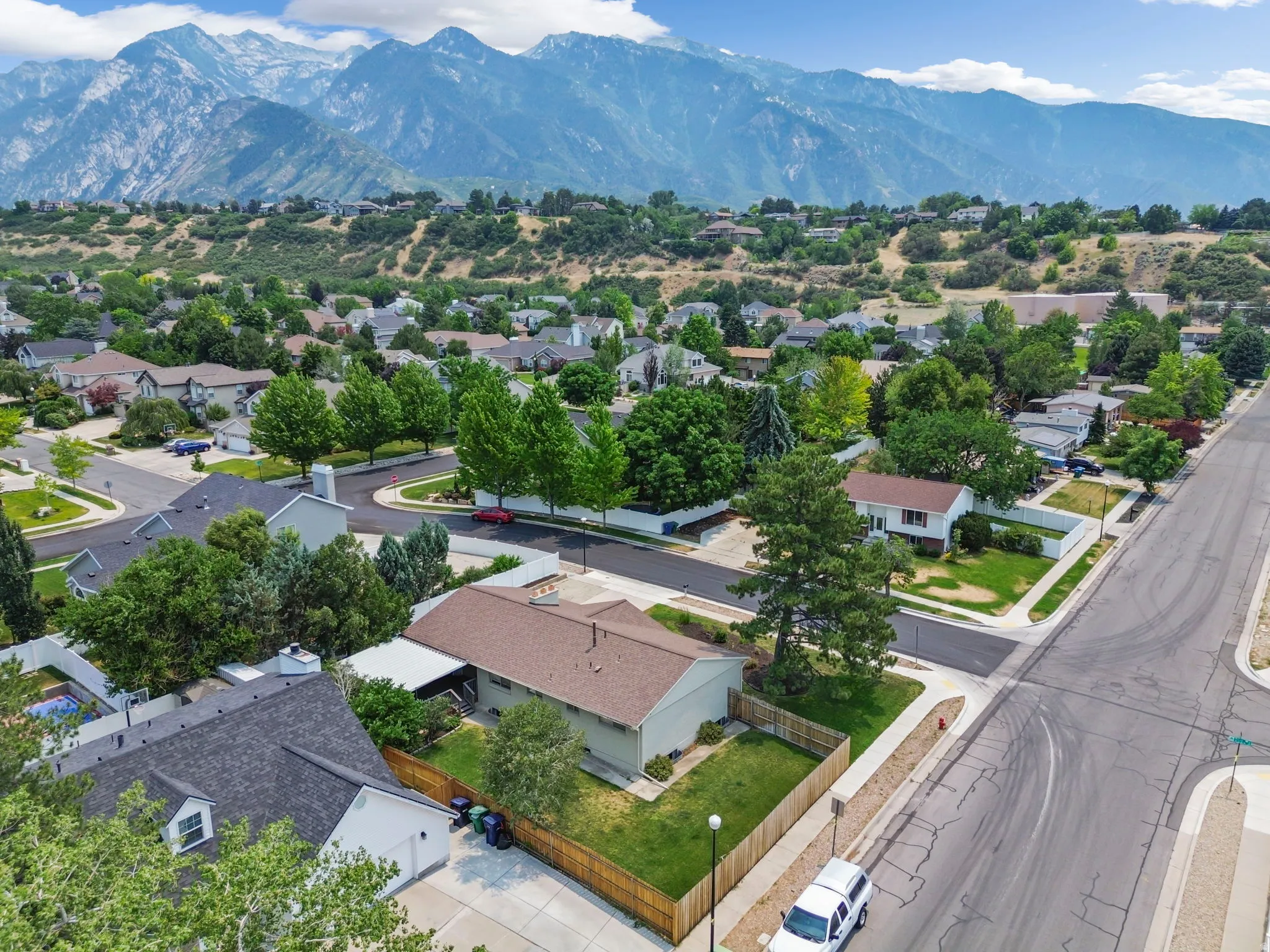 Aerial depiction of a residential neighborhood featuring established homes and mature trees