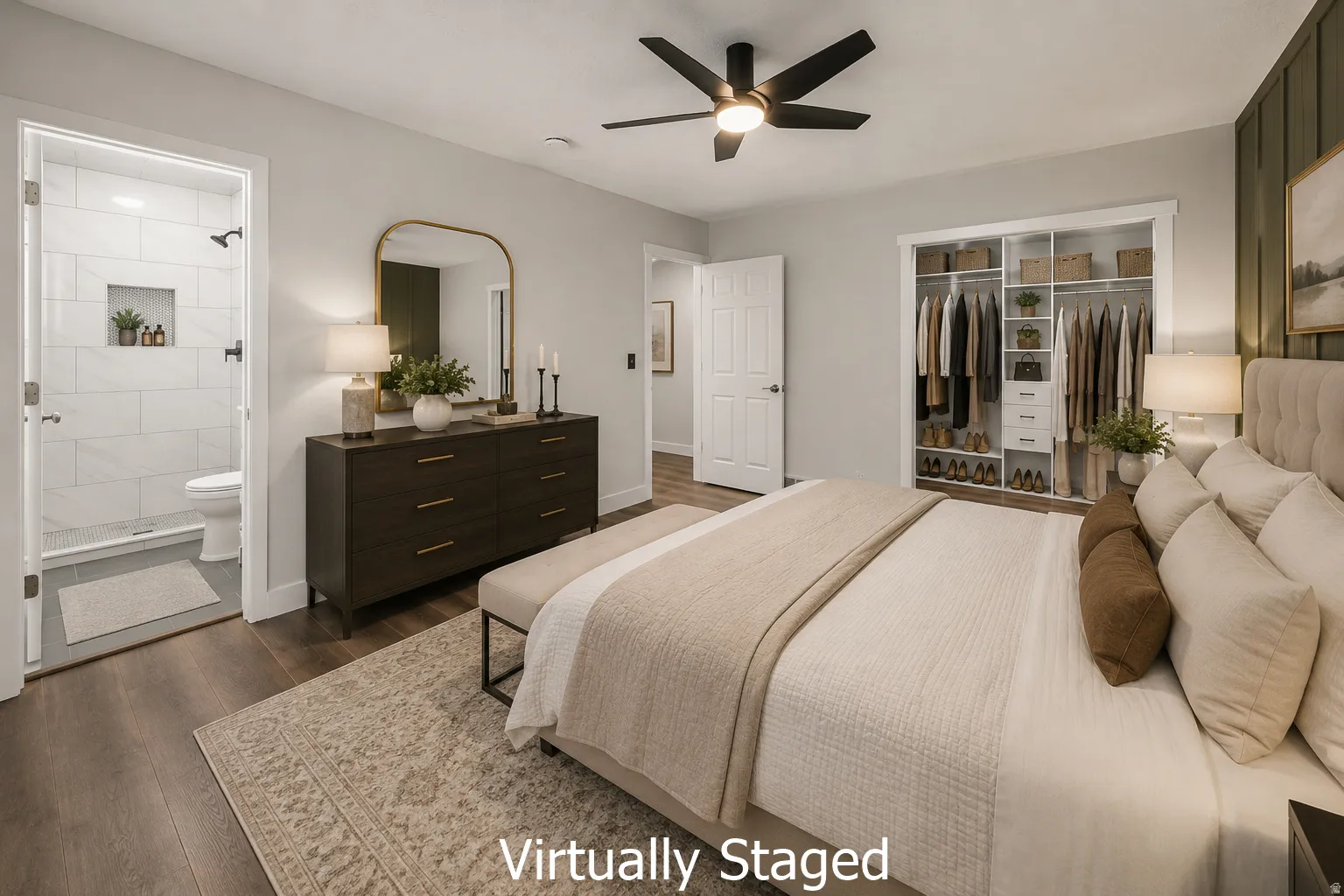 Bedroom featuring wood-finish flooring, a ceiling fan with integrated lighting, and a custom closet organization system