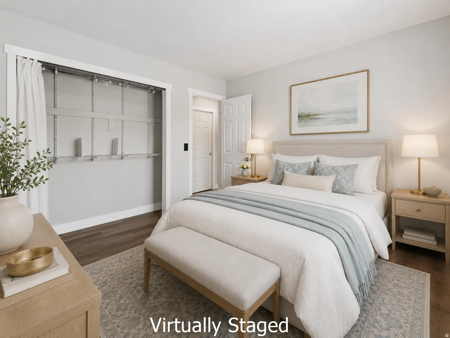 Bedroom featuring wood-finish flooring, light grey wall paint, and a built-in closet with adjustable shelving