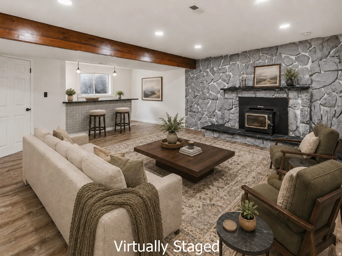 Spacious living area featuring a prominent stone accent wall with an integrated fireplace and wood-burning stove