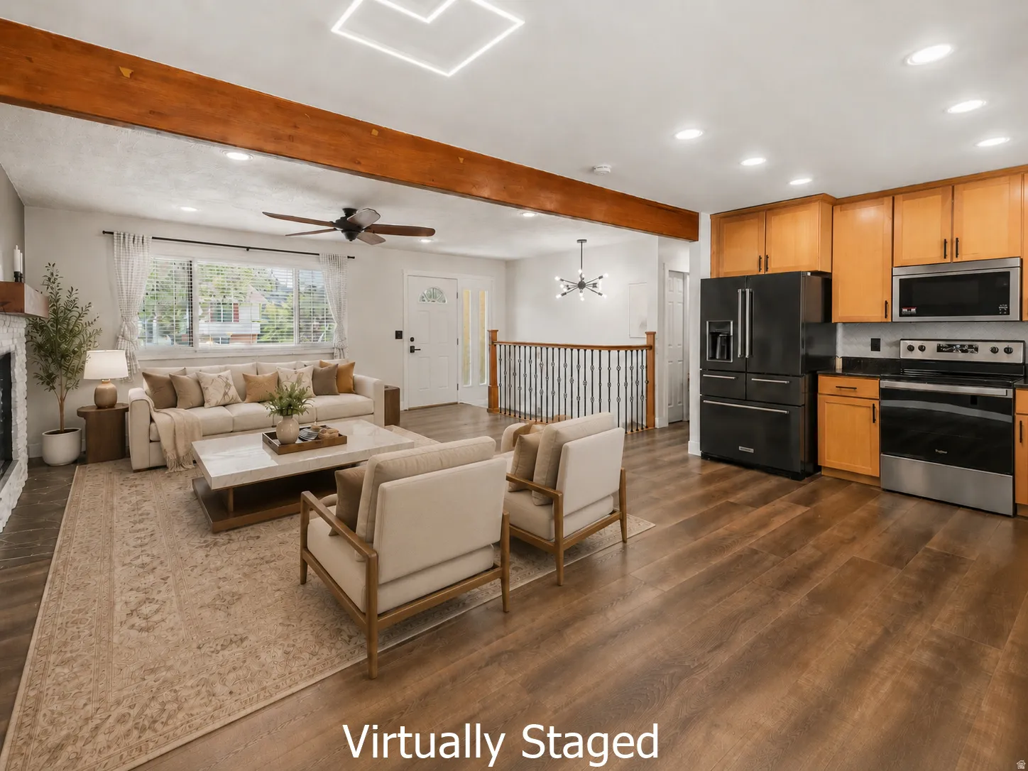 Open-concept living space featuring wood-finish flooring, exposed ceiling beams, recessed lighting, and a window allowing for natural light