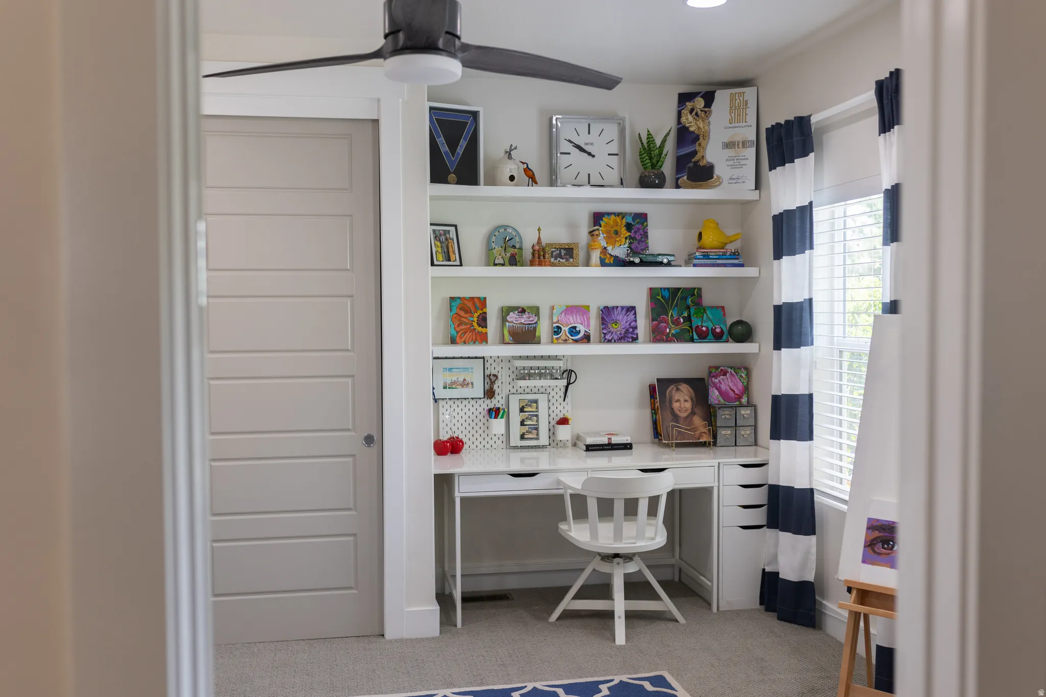 Bedroom or flex room. Built-in desk area featuring multiple shelving units and integrated drawers