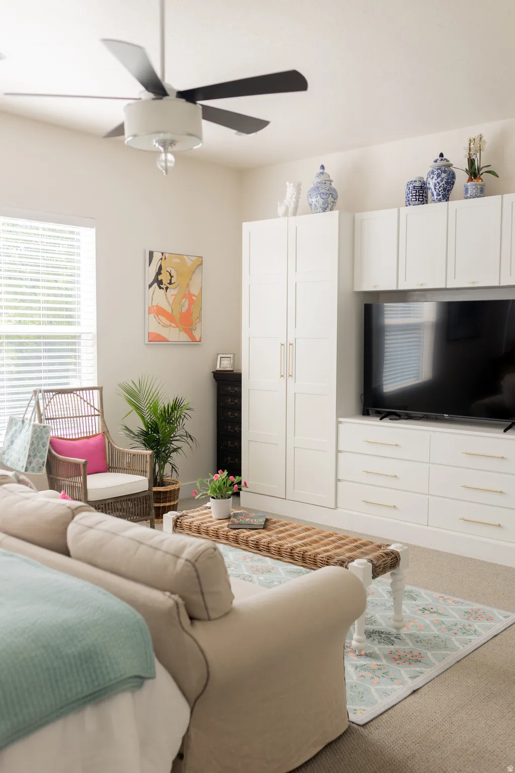 Primary bedroom on main floor. Built-in media center with white cabinetry.