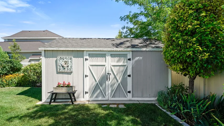 Garden shed with panel siding and double barn doors
