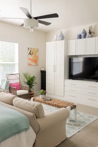 Primary bedroom on main floor. Built-in media center with white cabinetry.