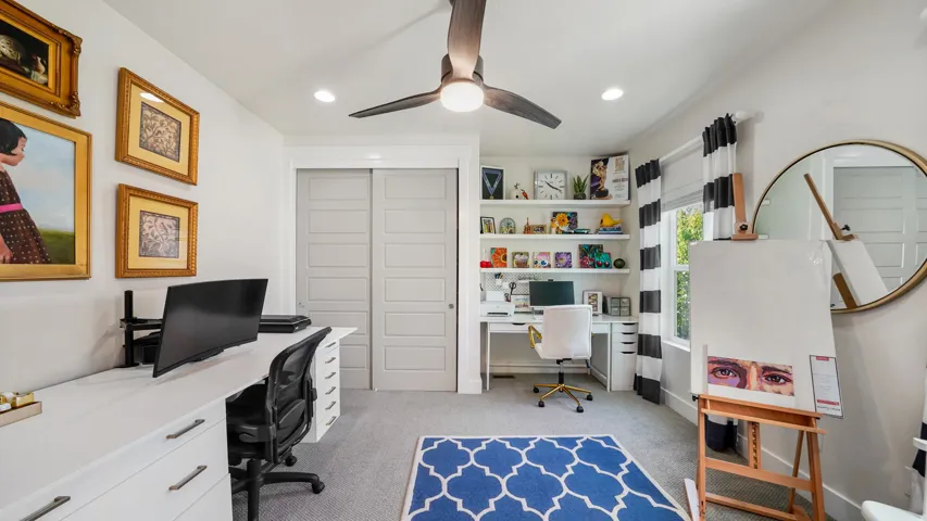 Bright room featuring a ceiling fan, recessed lighting, and a large window