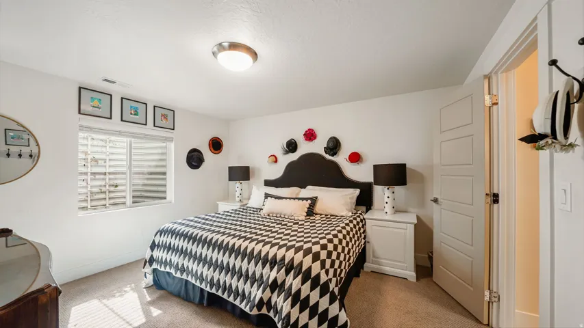 Carpeted room featuring a window with a window well, white walls, and a contemporary flush-mount ceiling light