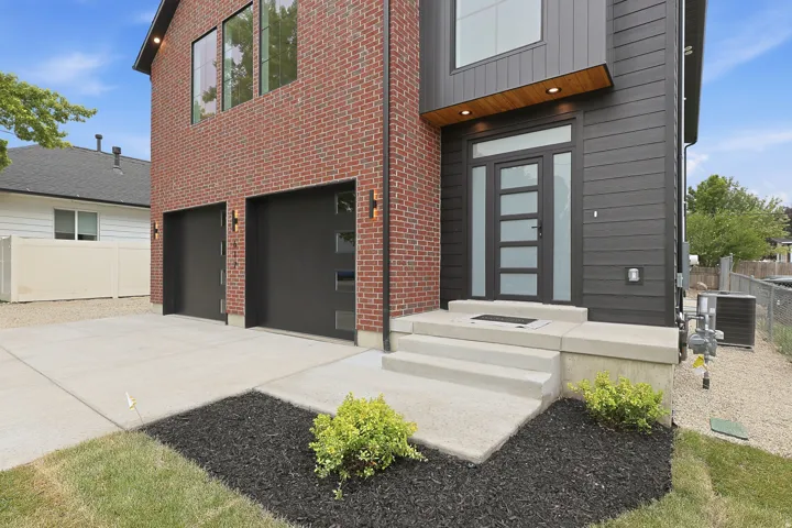Contemporary facade featuring red brick and dark horizontal siding