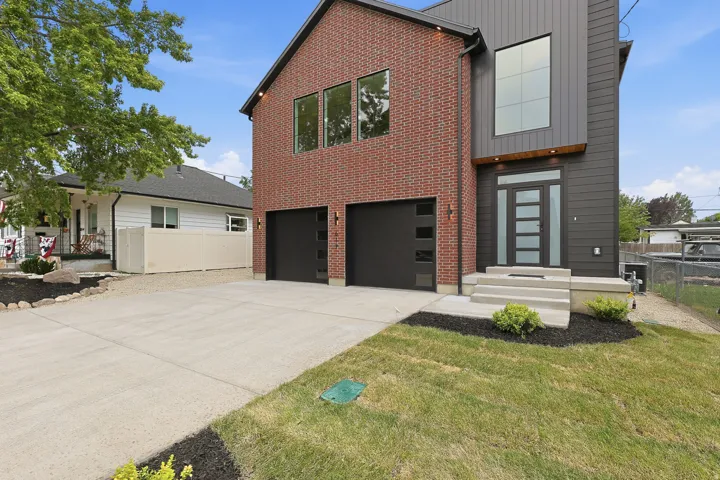 Modern facade featuring a combination of red brick and dark vertical siding