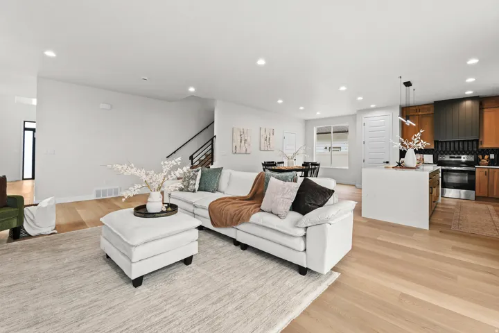Open-concept living space featuring light wood-finish flooring throughout
