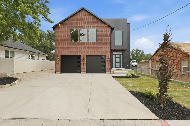Modern facade featuring a combination of brick and dark vertical siding