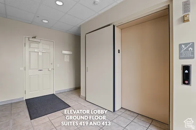 Elevator lobby featuring a tiled floor, recessed lighting, and a neutral color palette