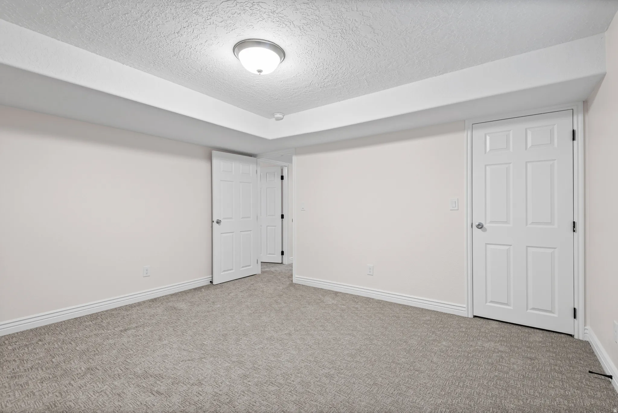 Neutral-toned carpeting and light wall paint throughout