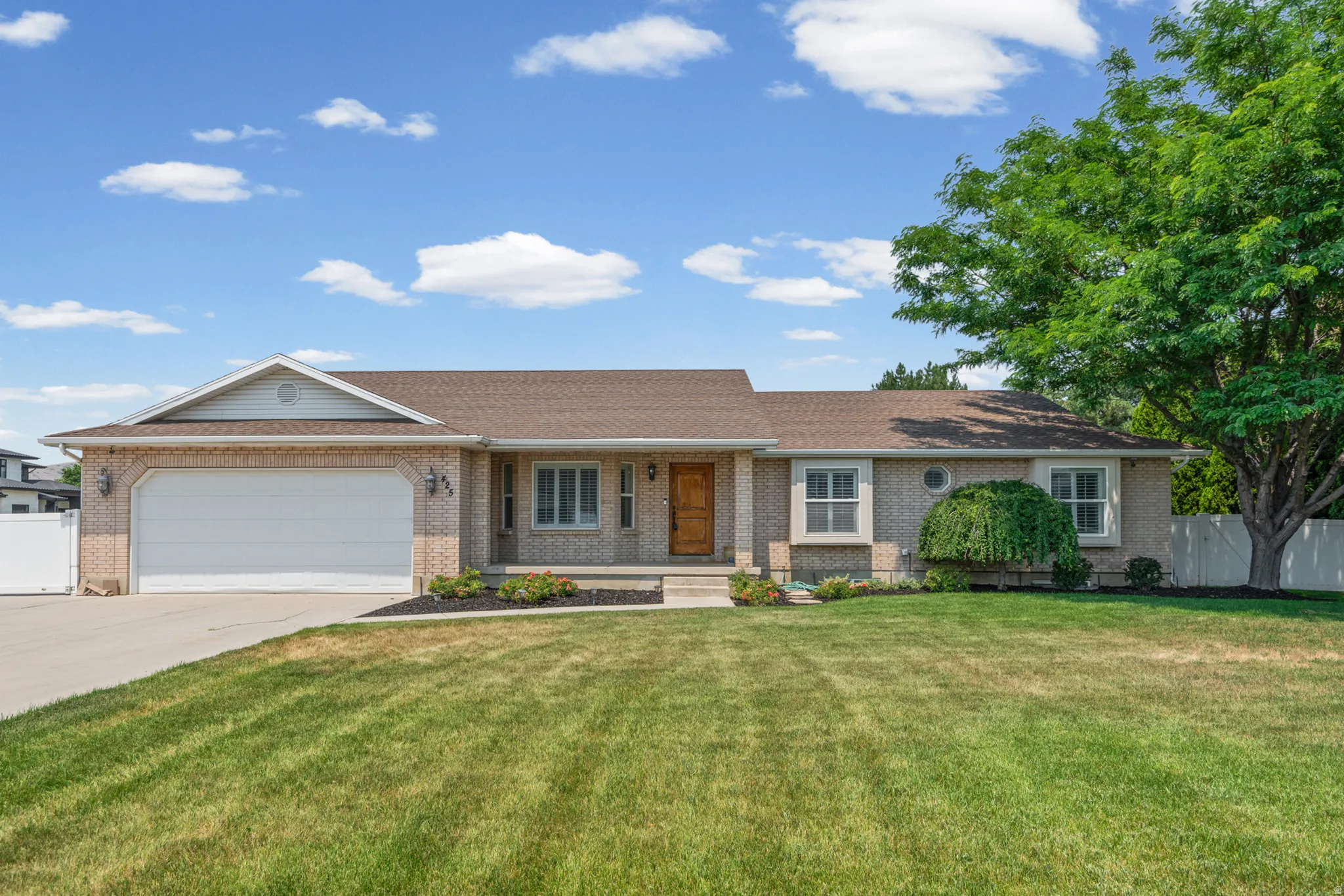 Brick exterior with a prominent attached garage and a concrete driveway
