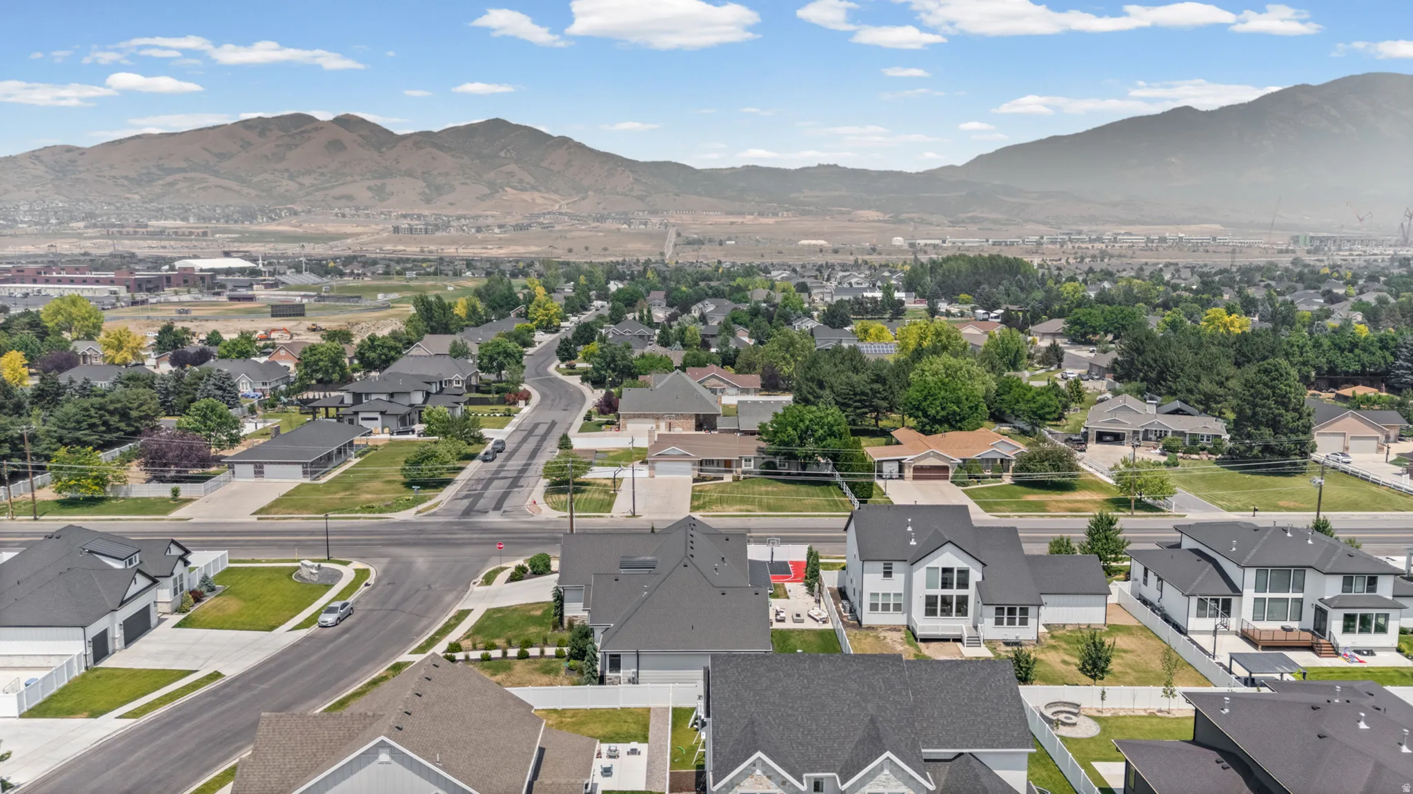 Residential neighborhood with mountain backdrop, established streets, and mature trees