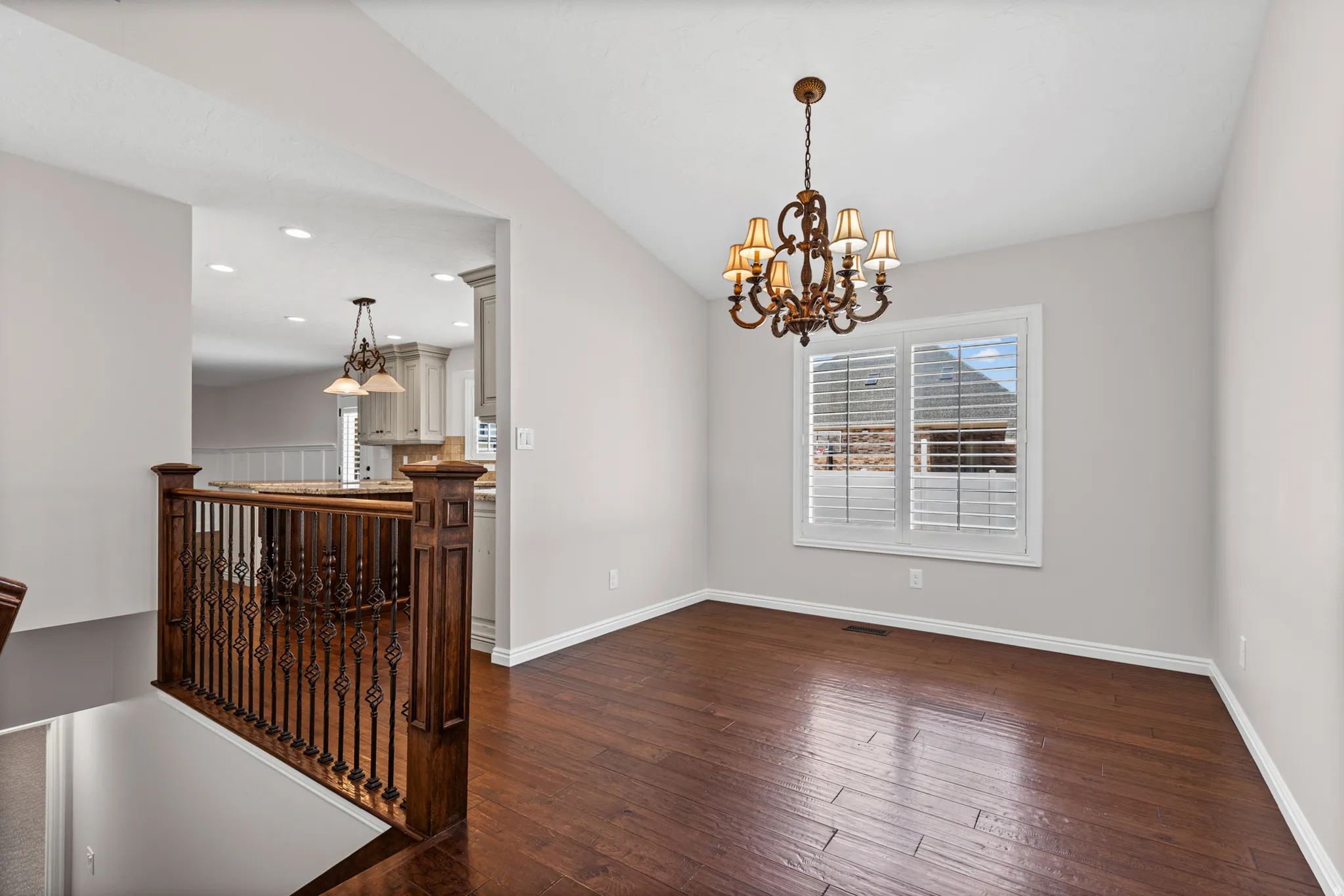 Dining area featuring wood-finish flooring and a decorative chandelier