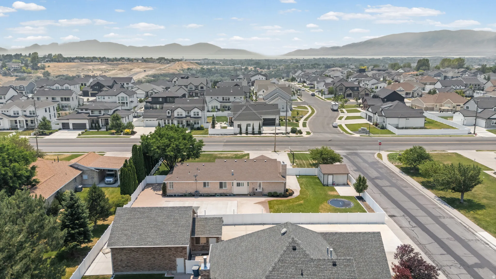 Aerial perspective showcasing a residential neighborhood with distant mountain scenery