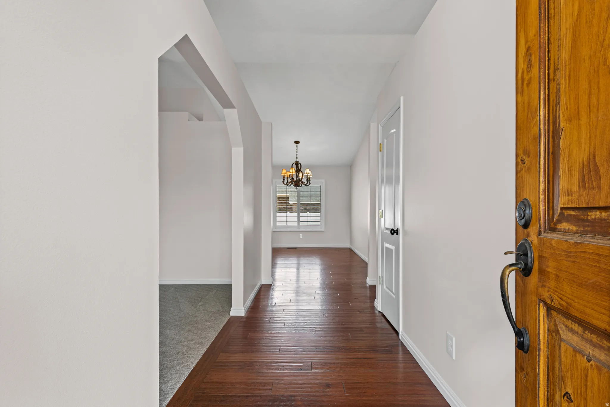 Inviting entryway with a solid wood front door and dark bronze hardware