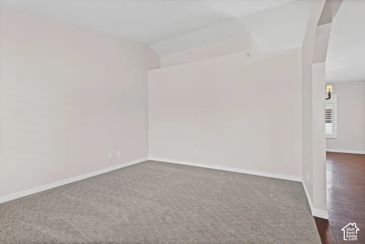 Neutral-toned walls complement the gray carpeting