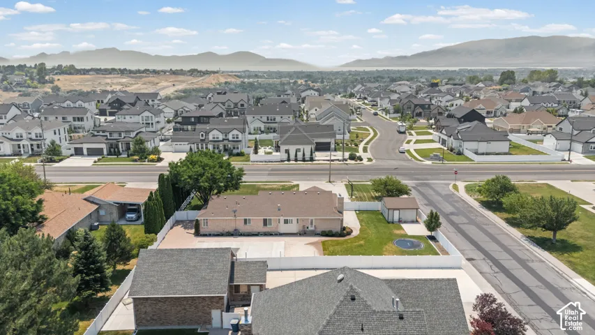 Aerial perspective showcasing a residential neighborhood with distant mountain scenery