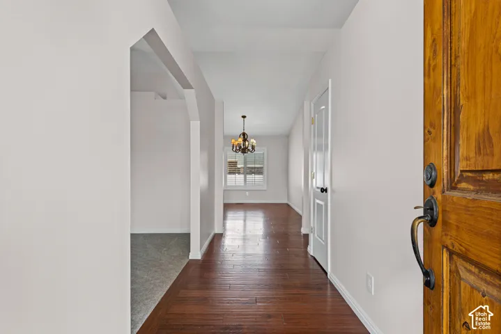 Inviting entryway with a solid wood front door and dark bronze hardware