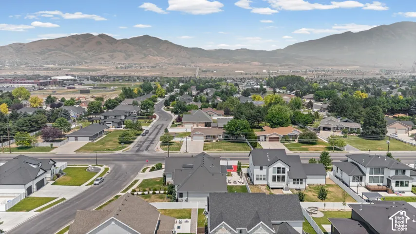 Residential neighborhood with mountain backdrop, established streets, and mature trees