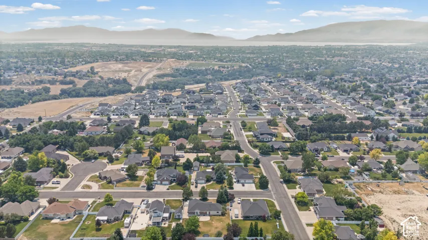 Expansive aerial perspective showcasing a developed residential neighborhood with established homes and tree-lined streets