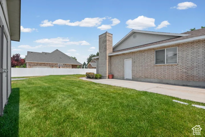Expansive green lawn with a white vinyl fence