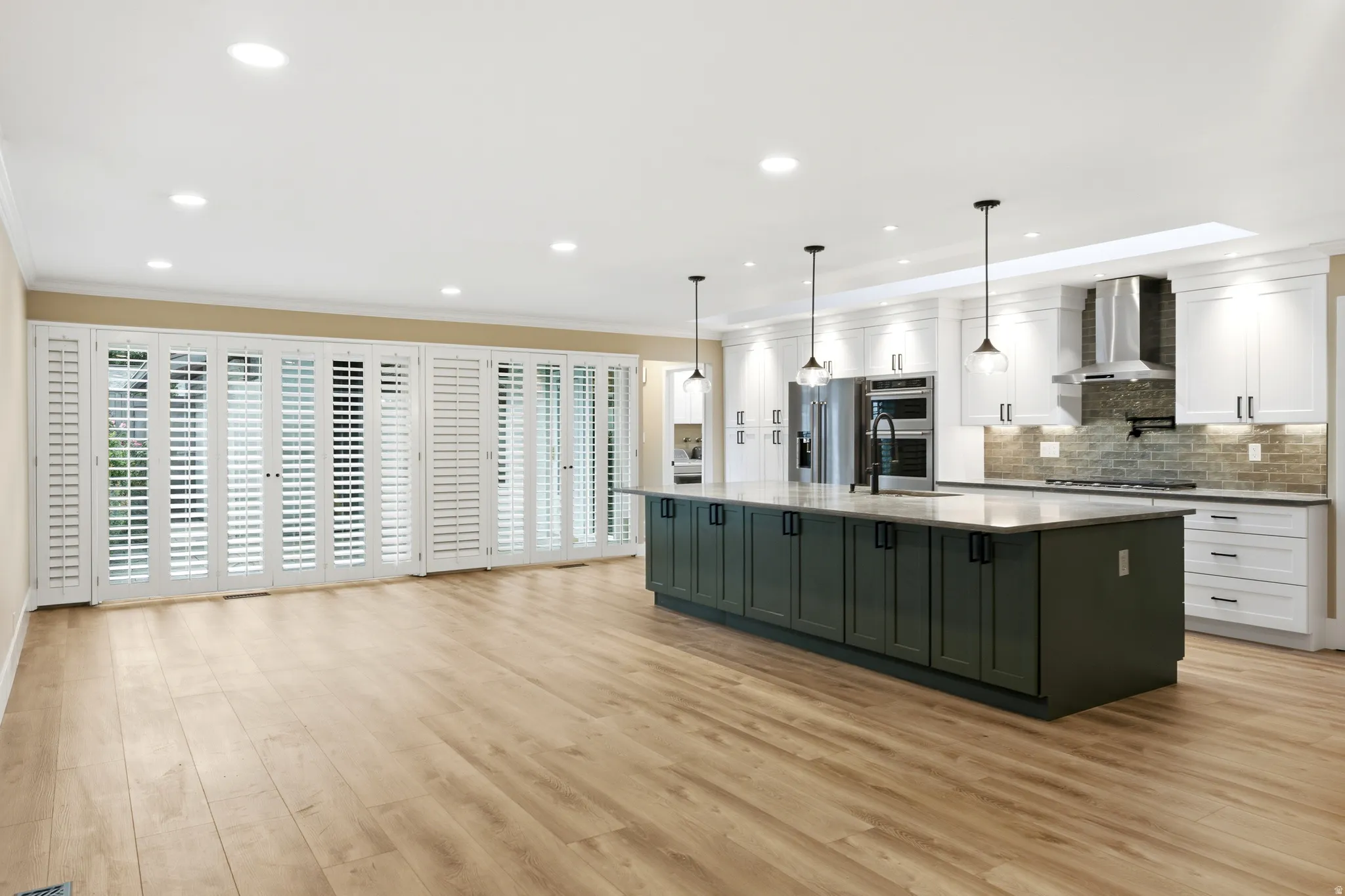 Open-concept kitchen and living area featuring wood-finish flooring