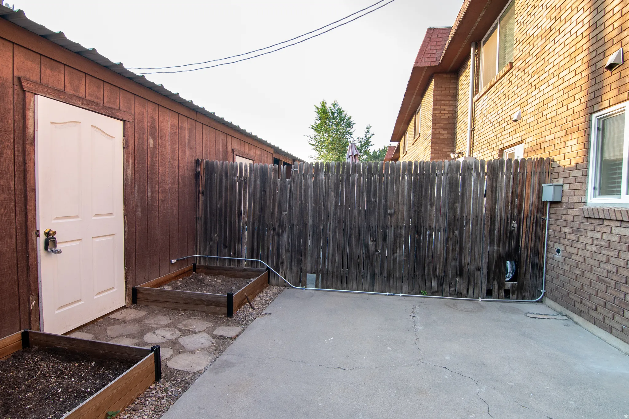 Private outdoor space featuring concrete paving and a privacy fence